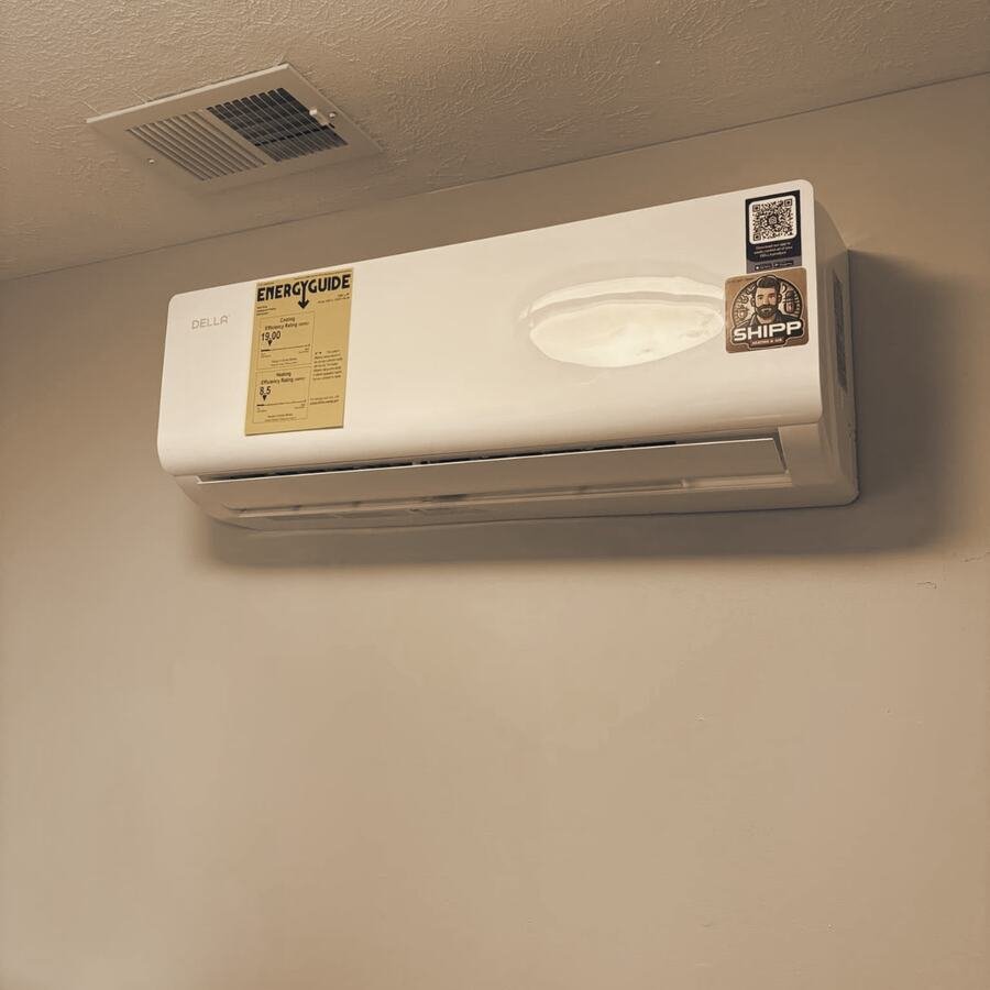A ductless mini split on a wall, the Energy Guide label and a SHIPP sticker still on it