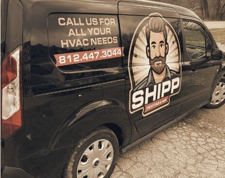 Shipp's black work van with the SHIPP logo, CALL US FOR ALL YOUR HVAC NEEDS and 812.447.3044 on the side