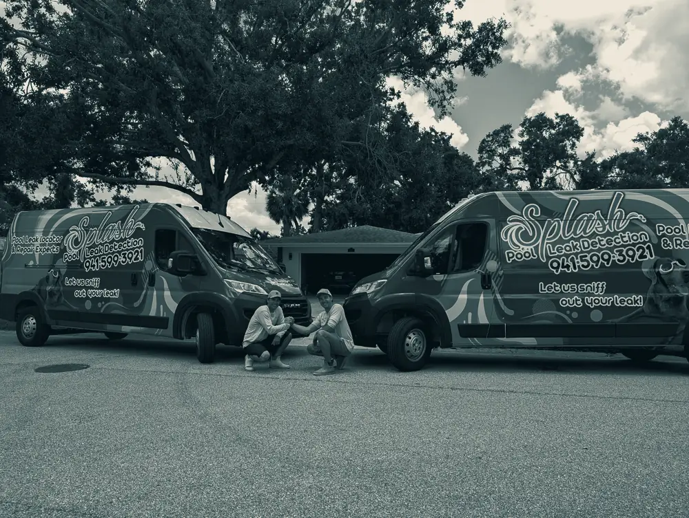 Two Splash Pool Leak Detection vans parked with the crew