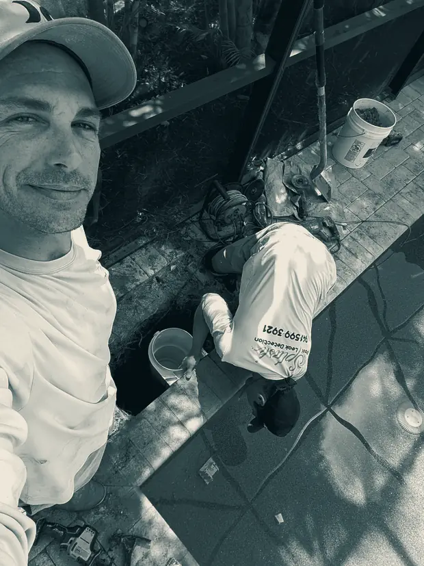 A Splash owner on a live pool job, crew working behind him